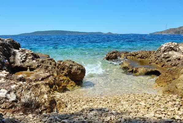Crystal-clear turquoise Adriatic water at the beach 30m away